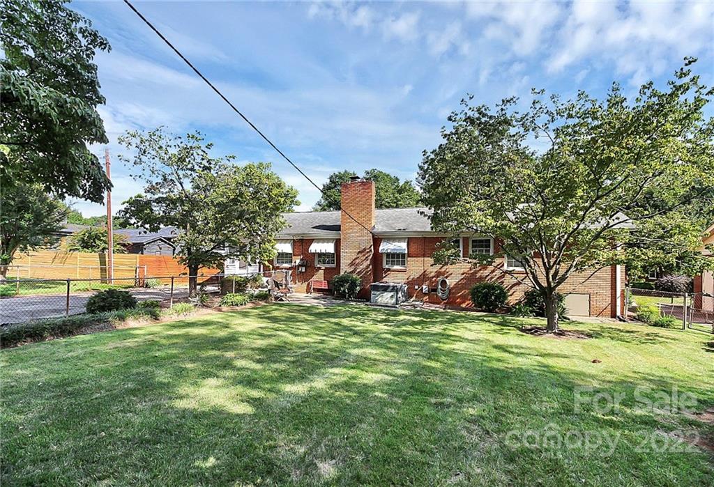 4114 Murrayhill Road Charlotte, NC 28209 - Photo 3 of 28 a view of a house with a big yard and large trees