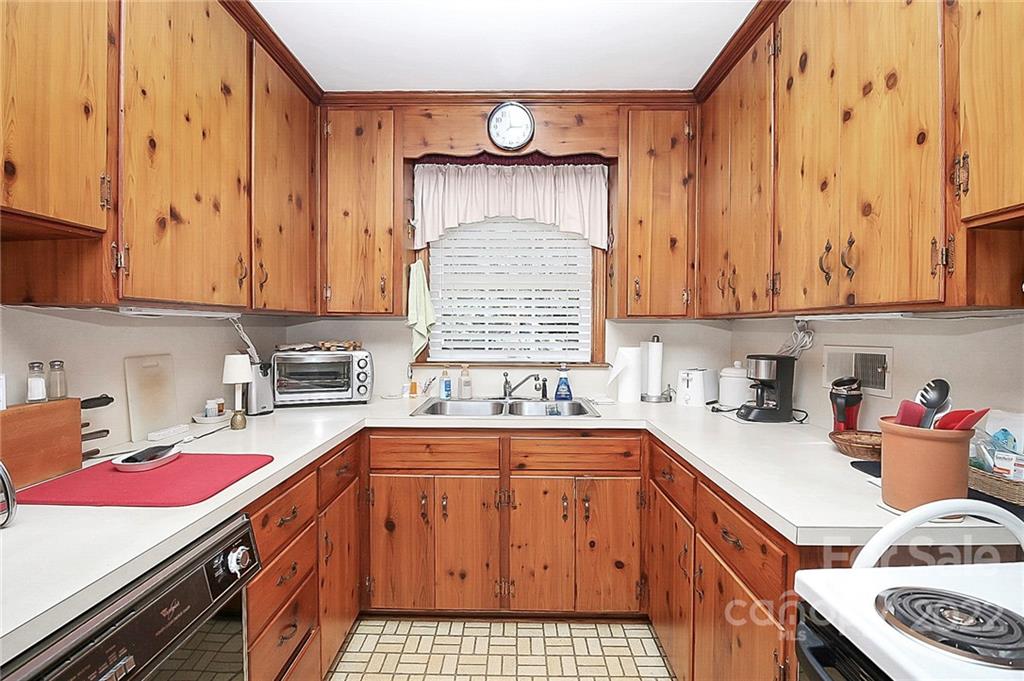 4114 Murrayhill Road Charlotte, NC 28209 - Photo 6 of 28 a kitchen with a sink stove and cabinets