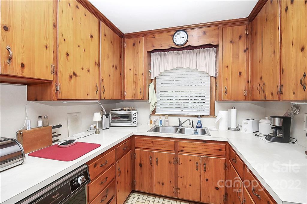 4114 Murrayhill Road Charlotte, NC 28209 - Photo 8 of 28 a kitchen with stainless steel appliances a sink stove and cabinets