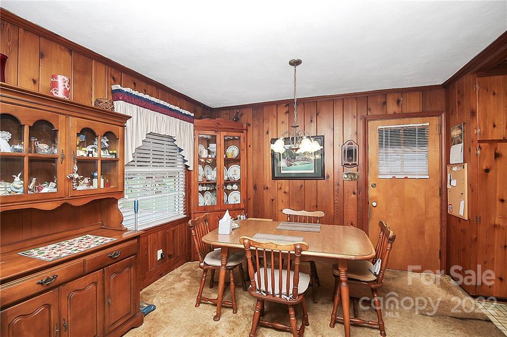 4114 Murrayhill Road Charlotte, NC 28209 - Photo 10 of 28 a dining room with furniture a window and chandelier