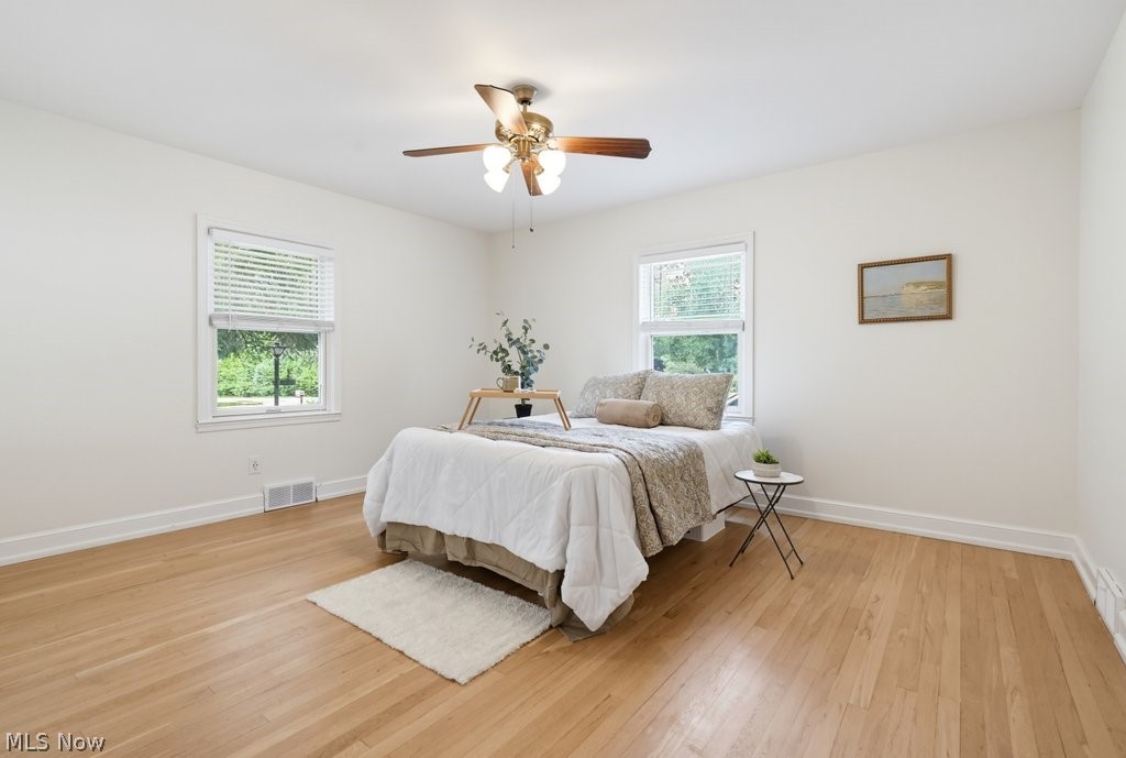 2468 Ridgewood Road Akron, OH 44313 - Photo 32 of 50 Light-filled room featuring hardwood flooring, white walls, and two large windows