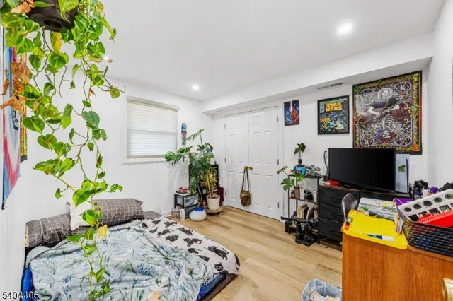 a living room filled with furniture and a potted plant