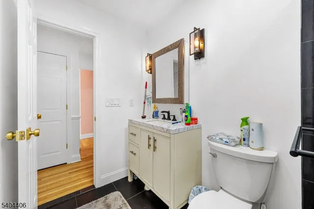 a bathroom with a sink toilet and mirror