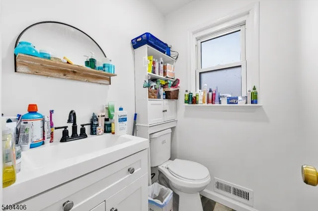 a bathroom with a sink mirror and toilet