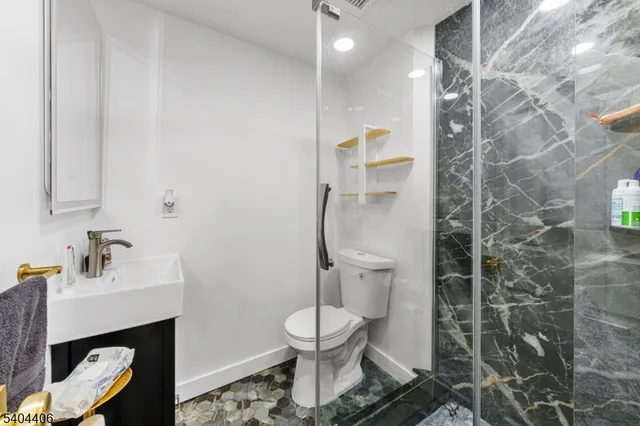 a bathroom with a sink toilet and a mirror