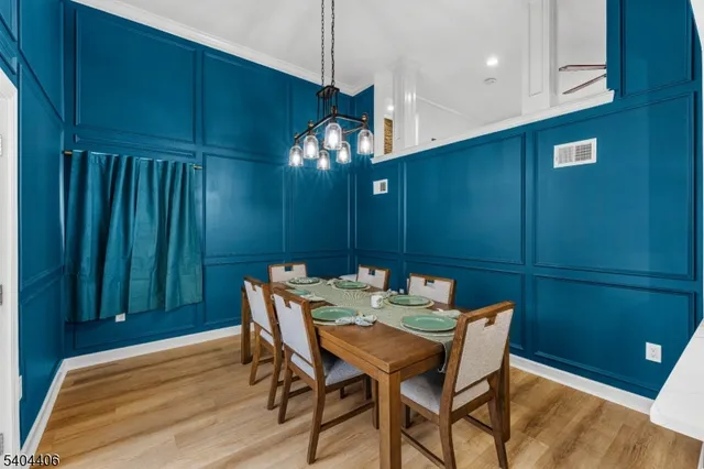 a view of a dining room with furniture and chandelier