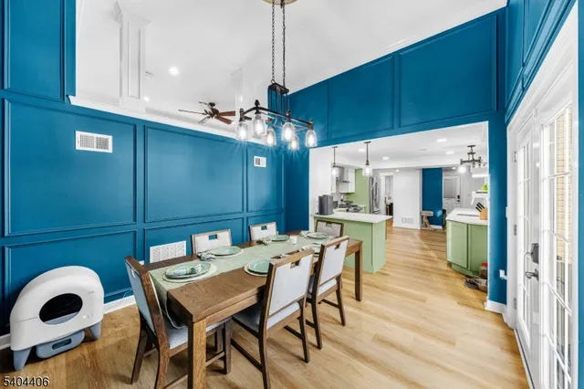 a view of a dining room with furniture and chandelier