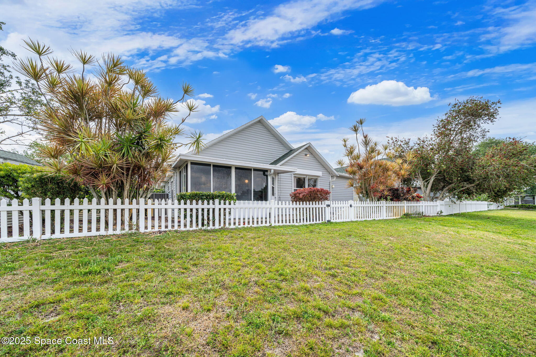3847 Town Square Boulevard, Unit 30 Melbourne, FL 32901 - Photo 11 of 36 a front view of a house with a garden