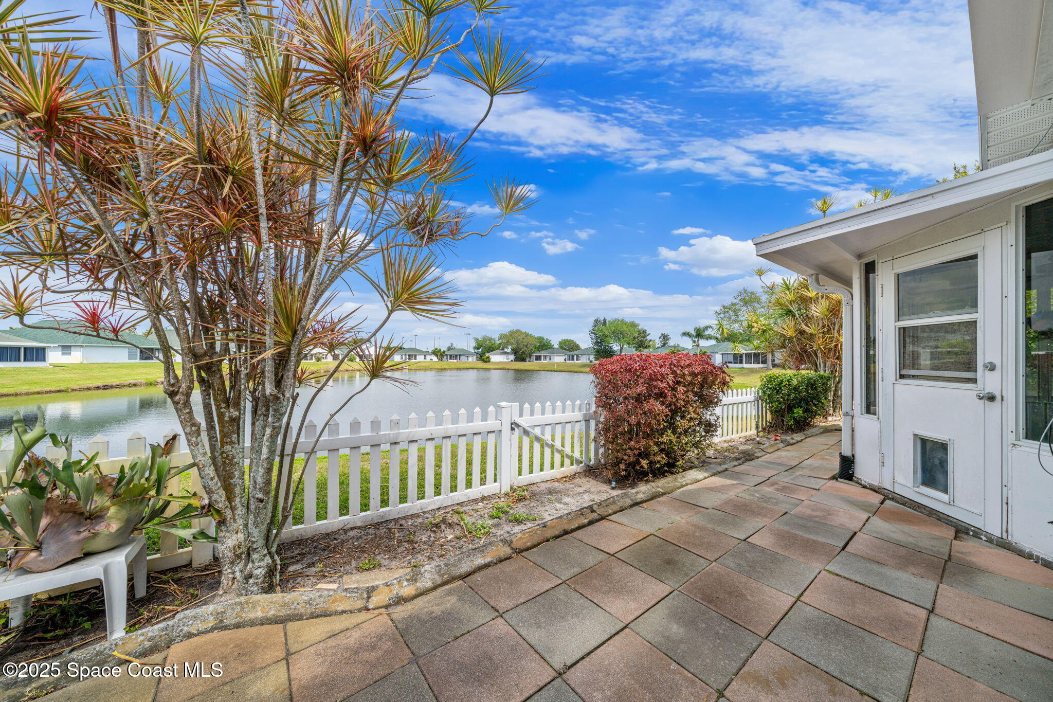3847 Town Square Boulevard, Unit 30 Melbourne, FL 32901 - Photo 13 of 36 a view of a pathway with a garden