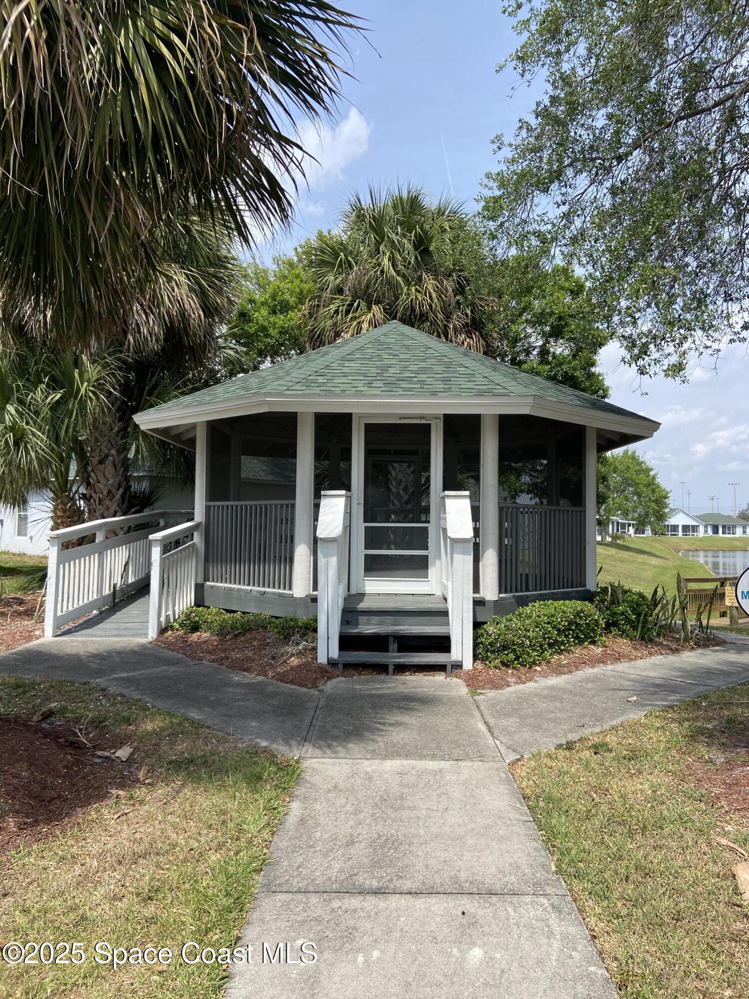 3847 Town Square Boulevard, Unit 30 Melbourne, FL 32901 - Photo 14 of 36 a front view of a house with a porch