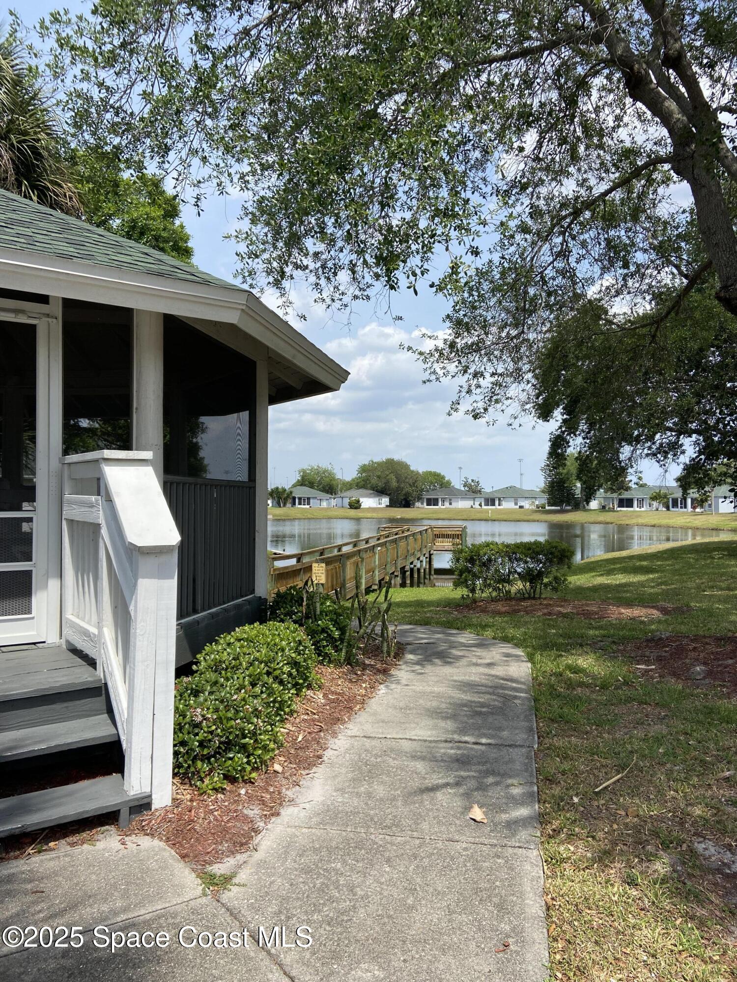 3847 Town Square Boulevard, Unit 30 Melbourne, FL 32901 - Photo 15 of 36 a view of a patio with a table chairs and a yard