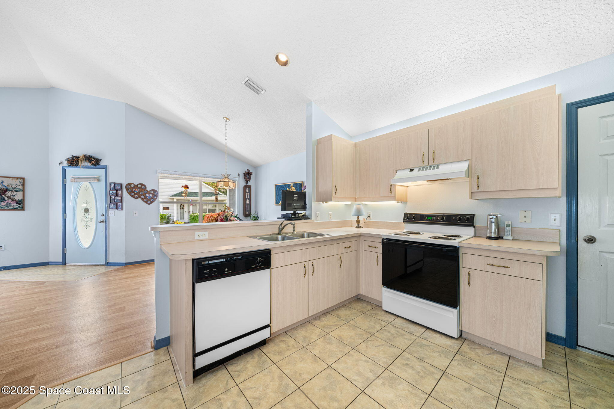 3847 Town Square Boulevard, Unit 30 Melbourne, FL 32901 - Photo 21 of 36 a kitchen with granite countertop white cabinets and white appliances