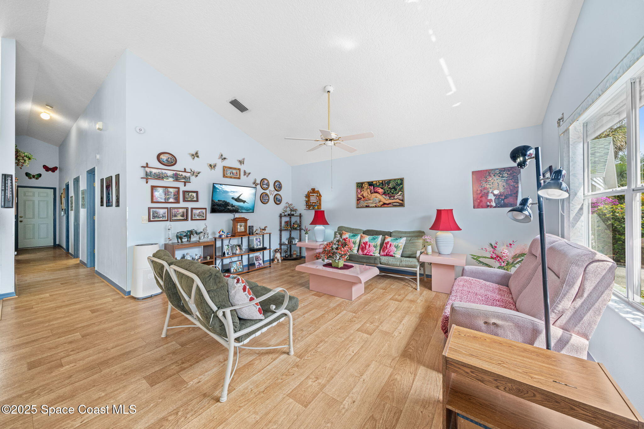 3847 Town Square Boulevard, Unit 30 Melbourne, FL 32901 - Photo 23 of 36 a living room with lots of furniture and wooden floor