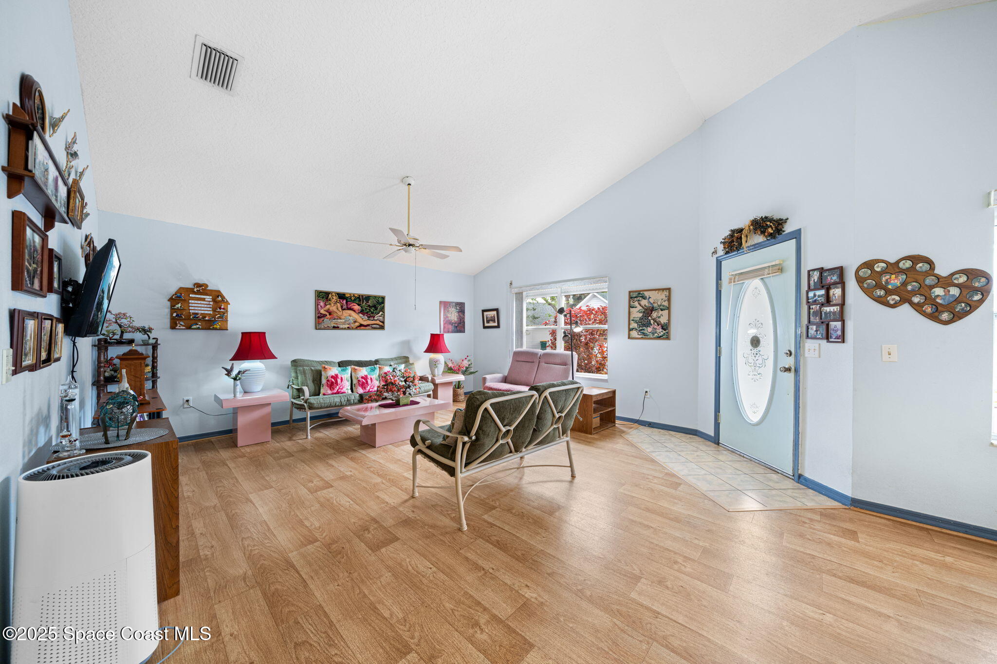 3847 Town Square Boulevard, Unit 30 Melbourne, FL 32901 - Photo 25 of 36 a living room with furniture and a wooden floor