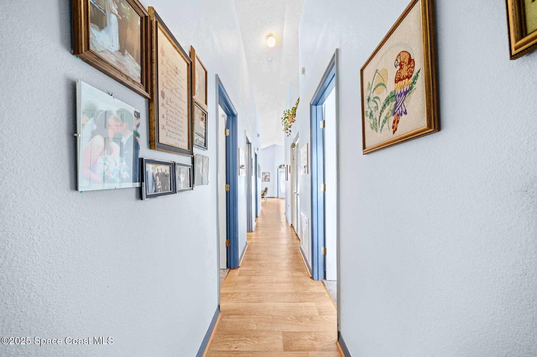 3847 Town Square Boulevard, Unit 30 Melbourne, FL 32901 - Photo 28 of 36 a view of a hallway with paintings on the wall