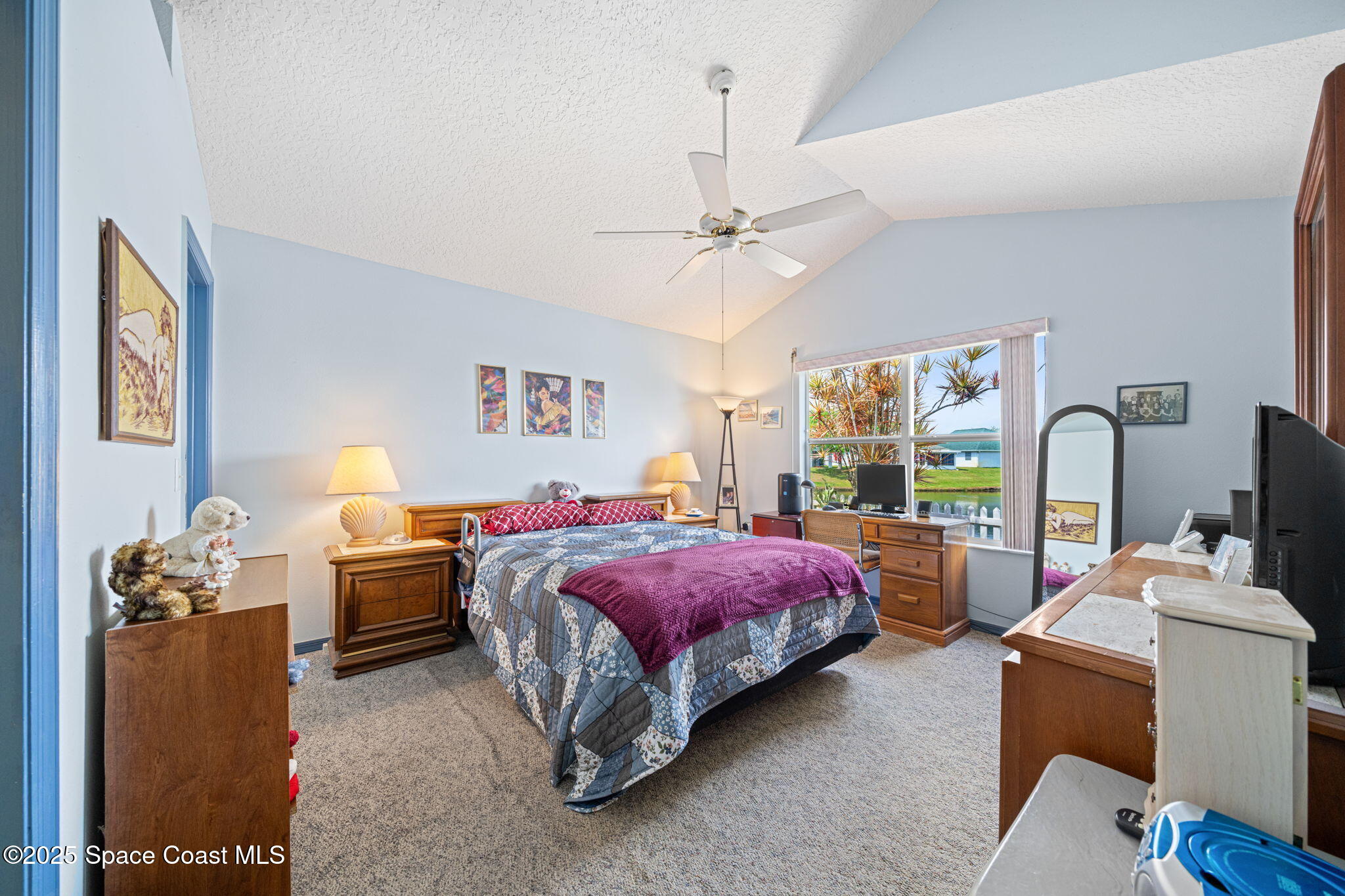 3847 Town Square Boulevard, Unit 30 Melbourne, FL 32901 - Photo 30 of 36 a bed room with a bed and a chandelier
