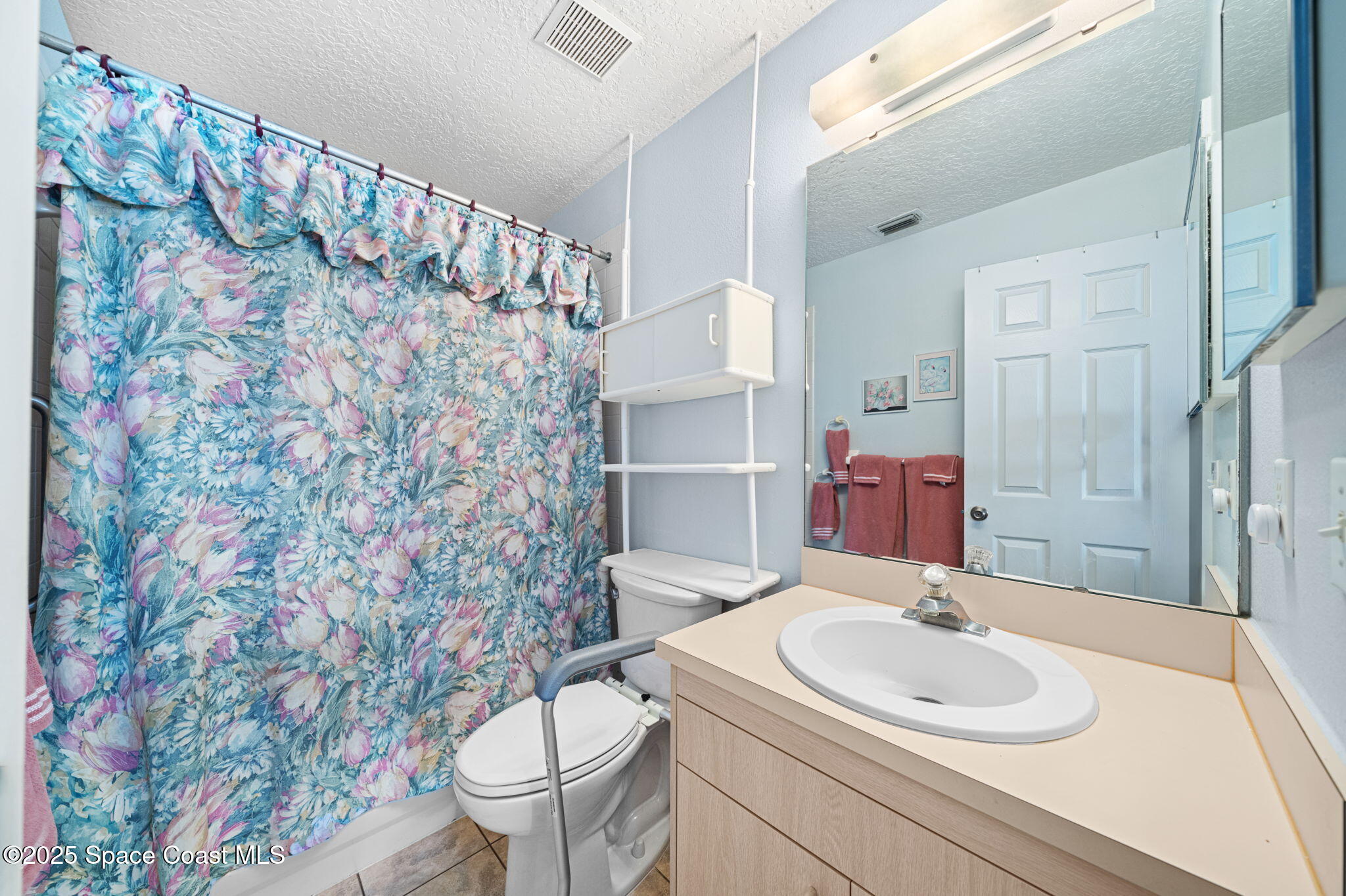 3847 Town Square Boulevard, Unit 30 Melbourne, FL 32901 - Photo 32 of 36 a bathroom with a sink toilet and a mirror