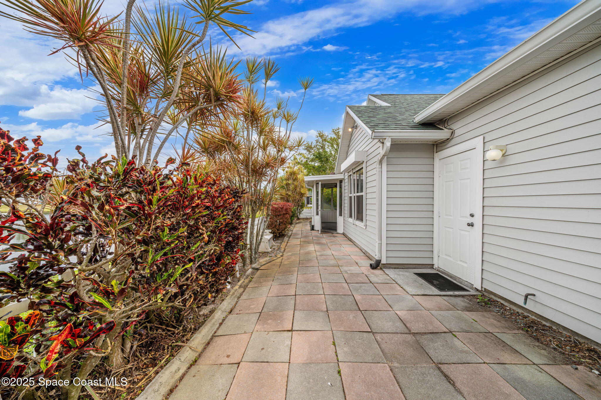 3847 Town Square Boulevard, Unit 30 Melbourne, FL 32901 - Photo 8 of 36 a view of a pathway with a yard