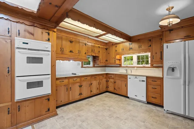 a kitchen with granite countertop cabinets stainless steel appliances and wooden floor