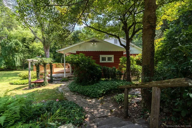 a view of a house with backyard and sitting area
