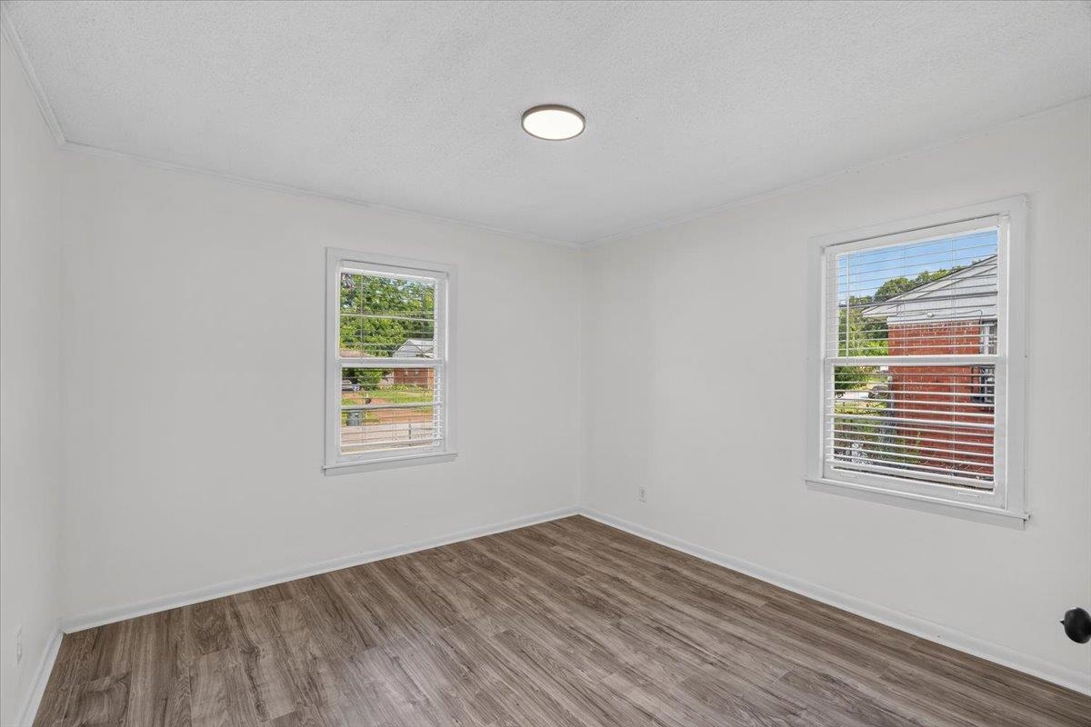 2717 Merle Street Memphis, TN 38118 - Photo 7 of 18 Room featuring wood-finish flooring, two windows with blinds, and white walls