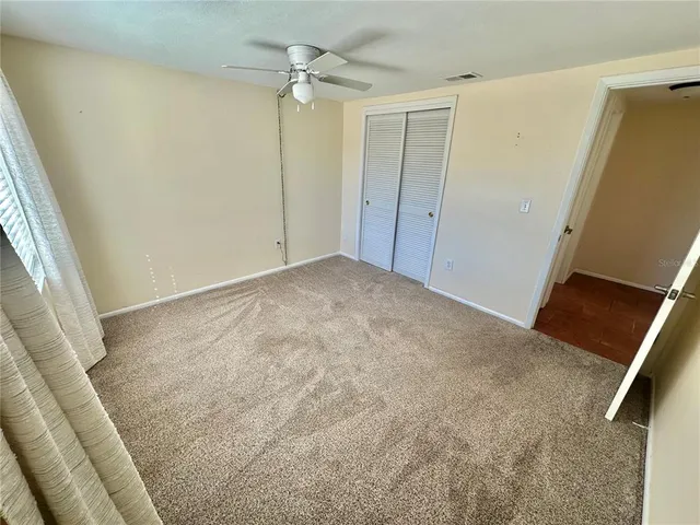 a view of room with a ceiling fan
