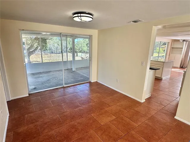 an empty room with large windows