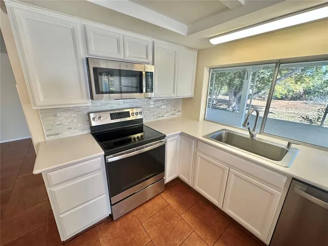 a kitchen with a stove and a sink