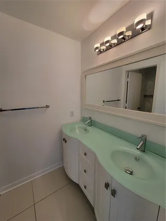 a spacious bathroom with a double vanity sink and a mirror