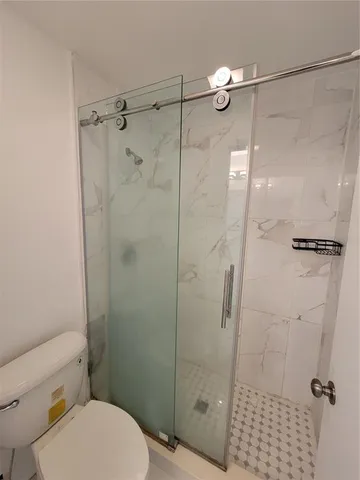 a bathroom with a shower and a toilet