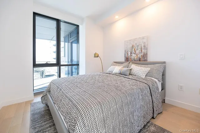 a bedroom with a large bed and a window