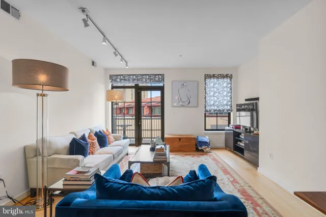 a living room with furniture and a lamp