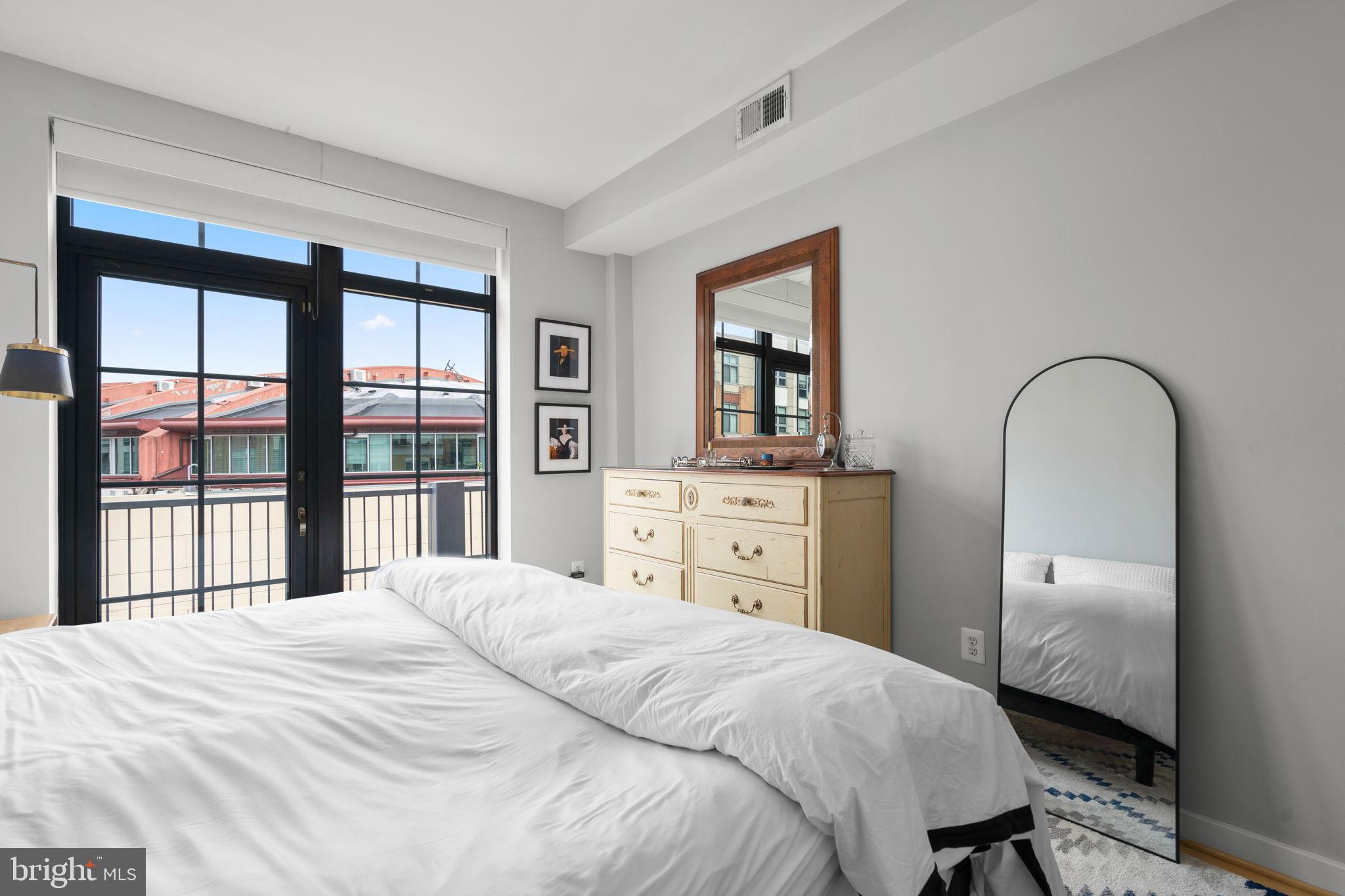 2412 17th Street Northwest, Unit 301 Washington, DC 20009 - Photo 14 of 18 a bedroom with a bed and a large window