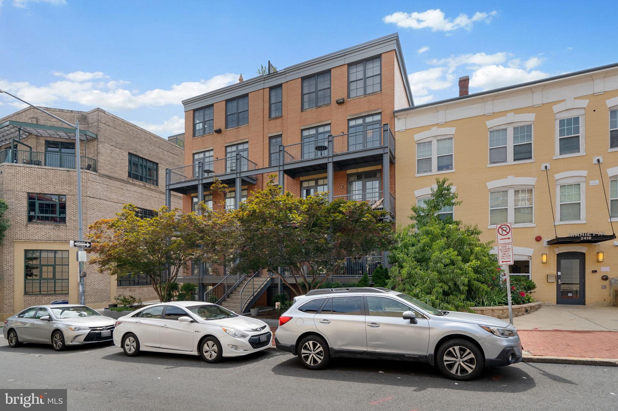 2412 17th Street Northwest, Unit 301 Washington, DC 20009 - Photo 2 of 18 a view of a cars park in front of a building