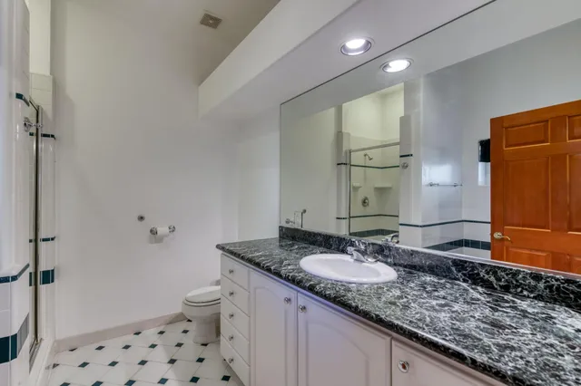 a kitchen with white cabinets and appliances