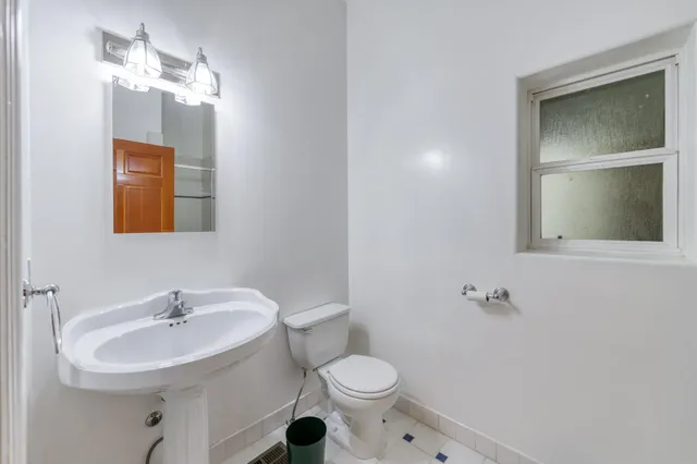 a view of a grassy field with trees in the background