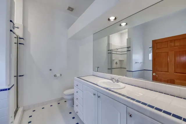 a front view of a house with a yard and potted plants