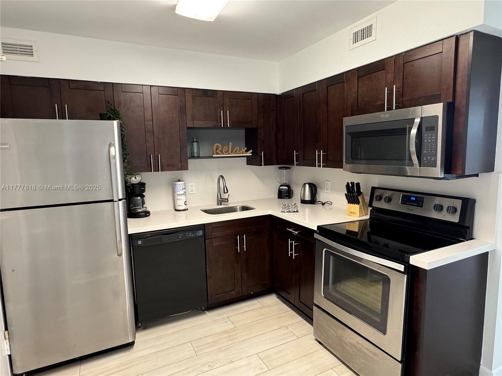 5161 Collins Avenue, Unit 1206 Miami Beach, FL 33140 - Photo 15 of 28 a kitchen with a refrigerator sink and microwave