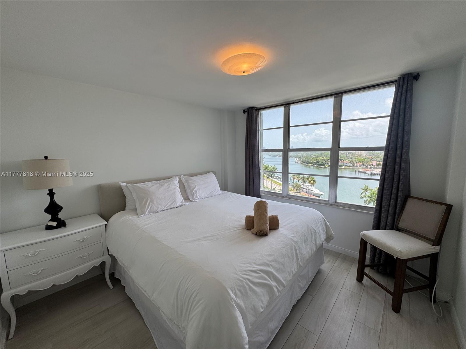 5161 Collins Avenue, Unit 1206 Miami Beach, FL 33140 - Photo 17 of 28 a bedroom with a bed and a large window