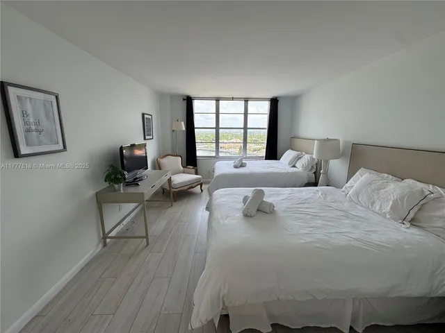 a bathroom with a double vanity sink toilet mirror and bathtub