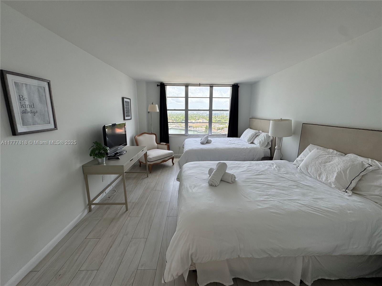 5161 Collins Avenue, Unit 1206 Miami Beach, FL 33140 - Photo 18 of 28 a large bedroom with a bed and large windows