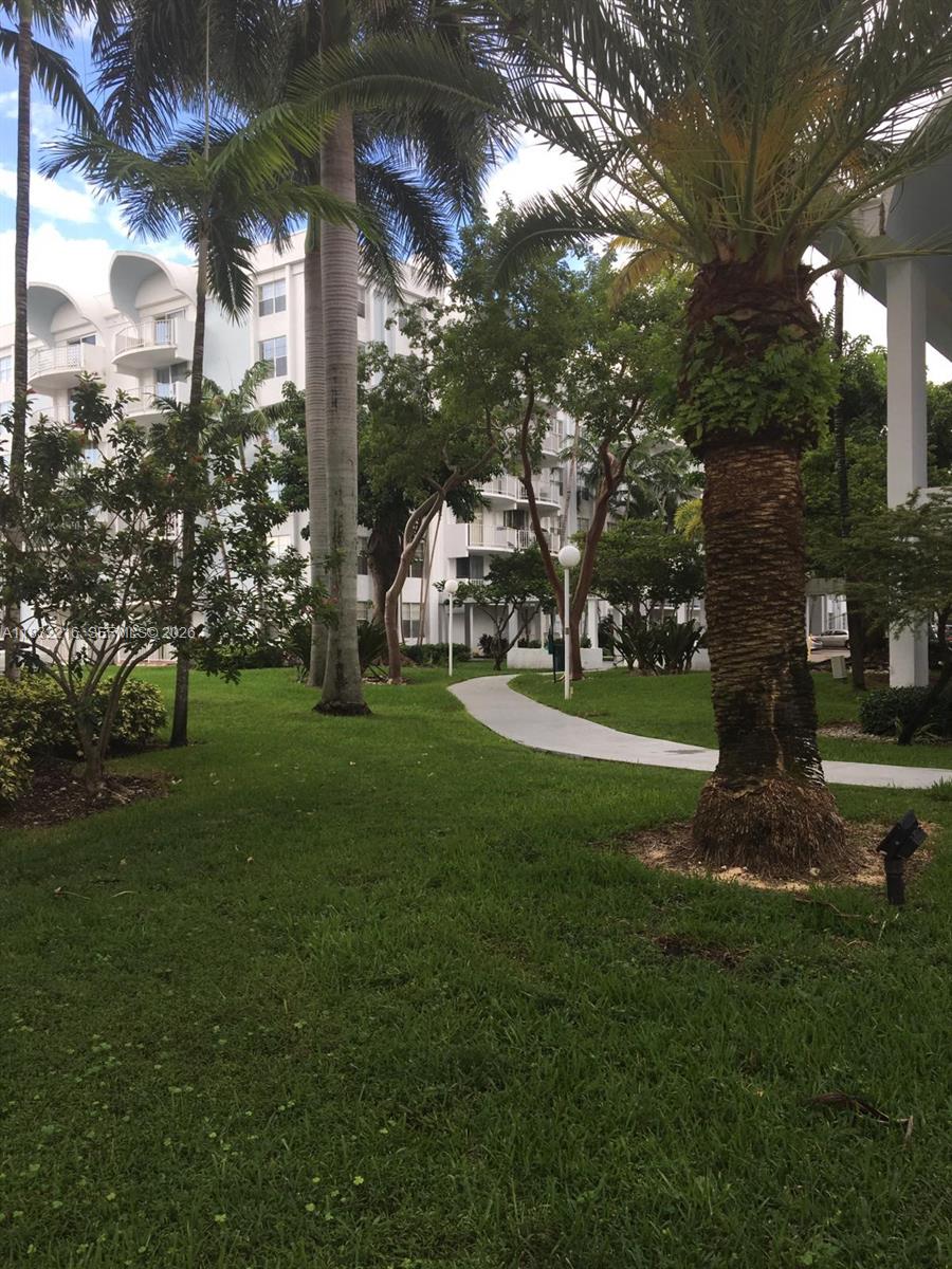 496 Northwest 165th Street, Unit D310 Miami, FL 33169 - Photo 11 of 16 a view of a park with large trees