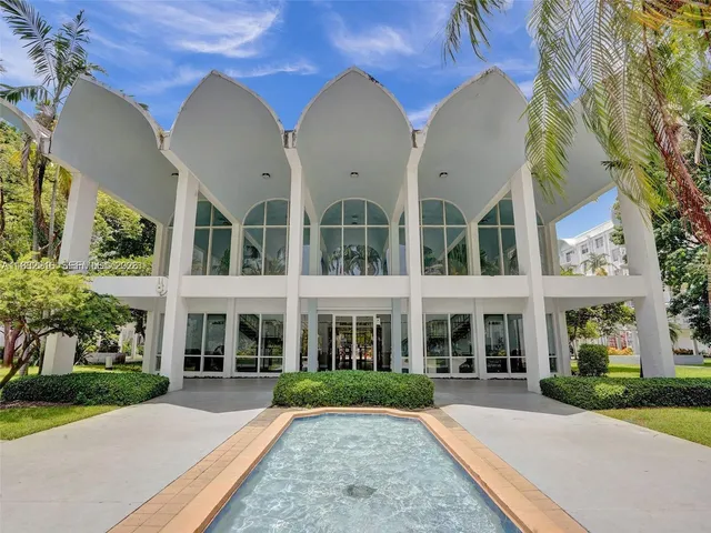a front view of a building with a garden
