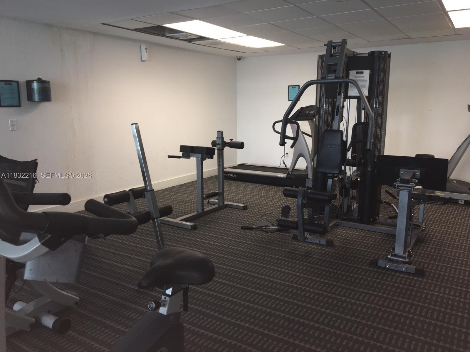 496 Northwest 165th Street, Unit D310 Miami, FL 33169 - Photo 10 of 16 a view of a room with gym equipment