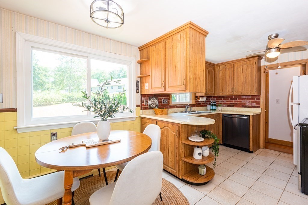 9 Linnea Lane Reading, MA 01867 - Photo 11 of 33 a kitchen with a stove a sink and a refrigerator
