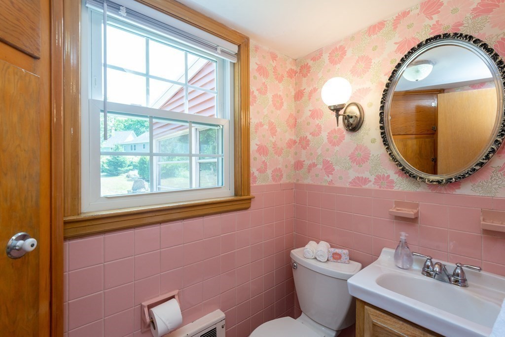 9 Linnea Lane Reading, MA 01867 - Photo 15 of 33 a bathroom with a toilet a sink and mirror