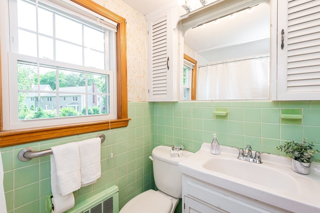 9 Linnea Lane Reading, MA 01867 - Photo 21 of 33 a bathroom with a sink mirror toilet and next to a window