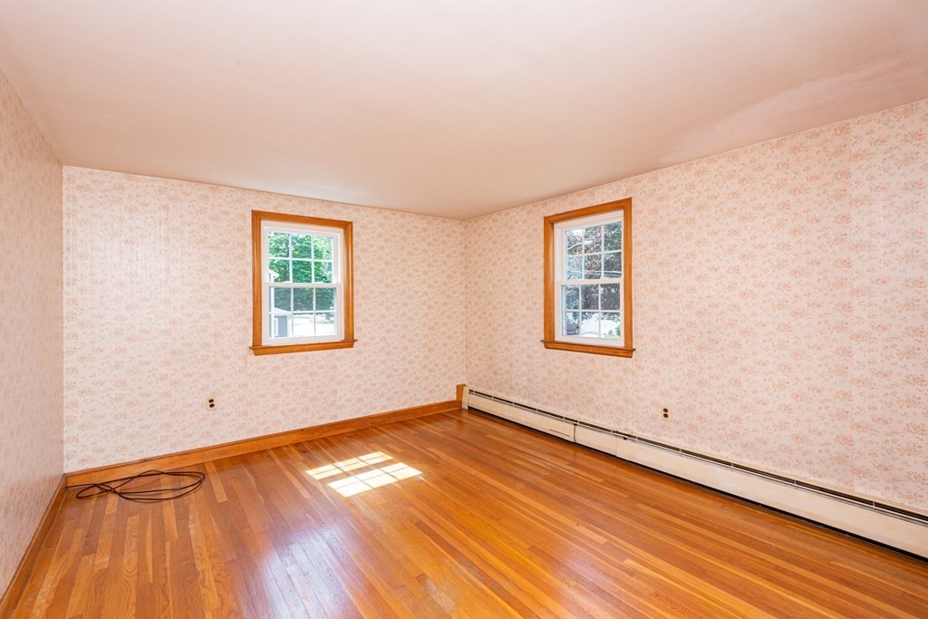9 Linnea Lane Reading, MA 01867 - Photo 24 of 33 a view of empty room with wooden floor and fan