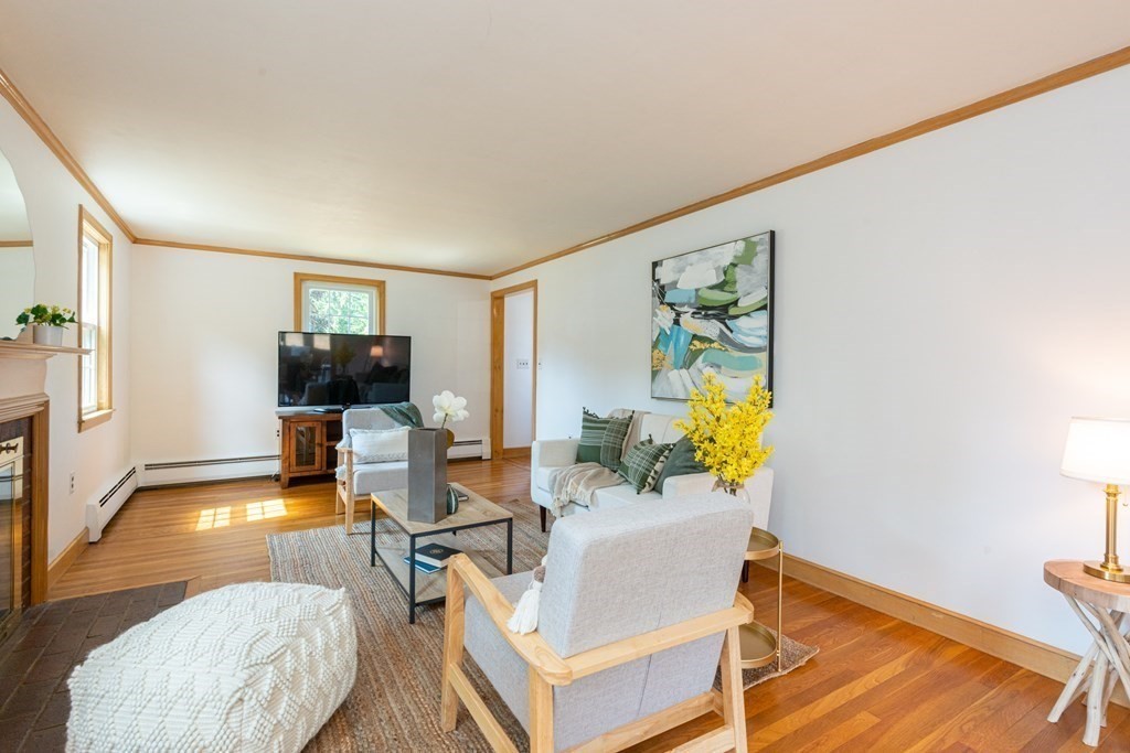 9 Linnea Lane Reading, MA 01867 - Photo 6 of 33 a living room with furniture and a flat screen tv