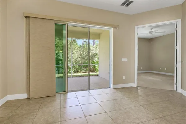 a view of an empty room with window and a bathroom